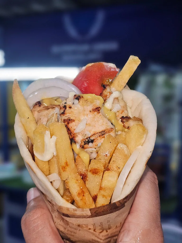 Grilled chicken and mozzarella pita with golden fries at Olympian