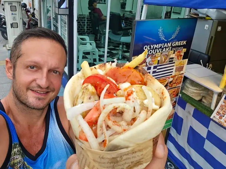 Yannis Pagiannidis holding a pita at Olympian Greek Souvlaki Pattaya