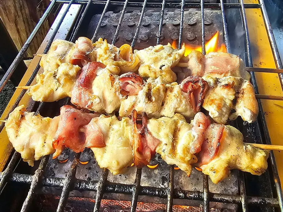 Skewers grilling over open flame