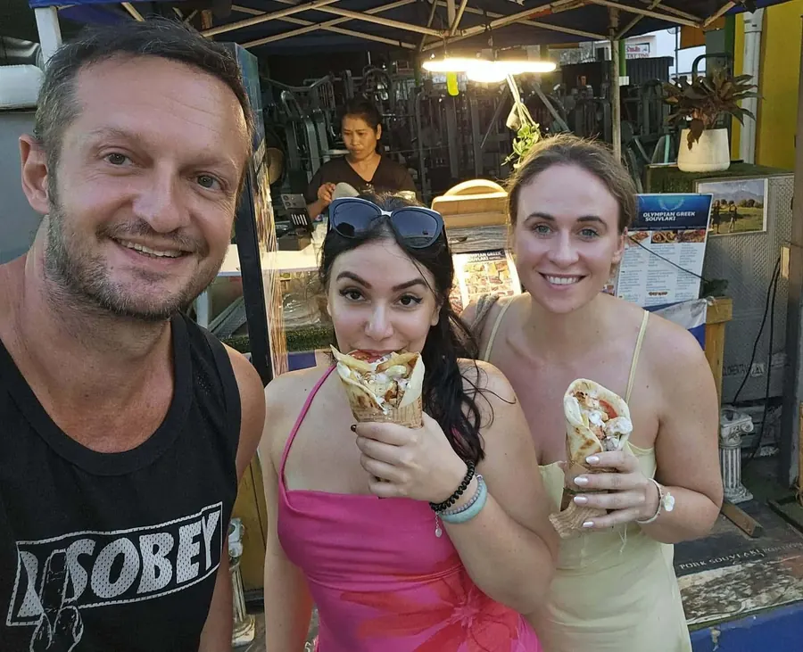Three friends enjoying souvlaki together